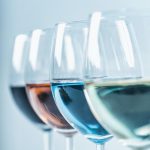 Wine Varieties. Four Glasses of Wine on Table – Red Wine, Rose, White and Blue Wine